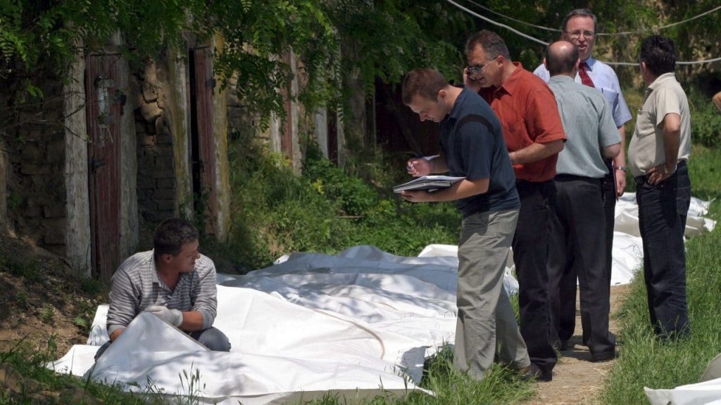 Serbian and UN investigators with body bags containing the remains of ethnic Albanians ready for return to Kosovo in May 2005, after they were exhumed from a police training centre in Batajnica in Serbia. Photo: EPA/Saša Stanković